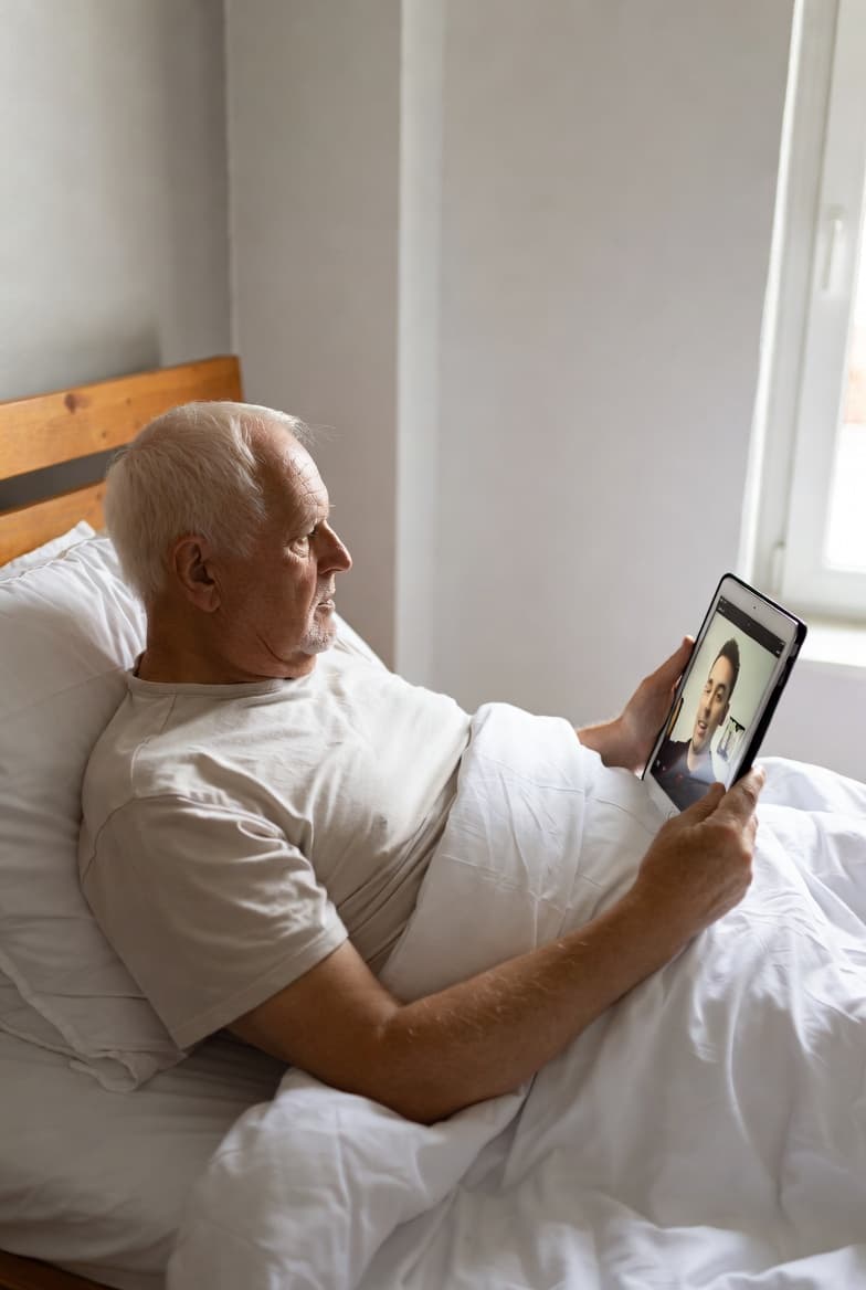 Elderly man video calling family